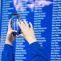Student takes photo of list of I am Grand Valley nominees